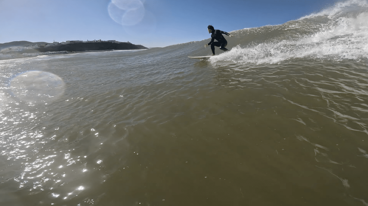 Surfer riding a wave along the Moroccan coastline.