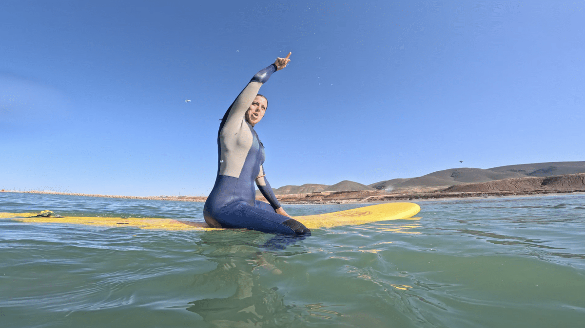 Surfer on an orange board riding a wave in Morocco.